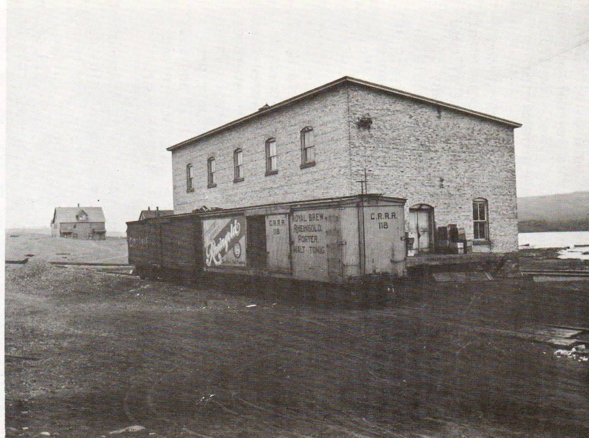 Scheuermann bottling house with freight car for Copper Range Railroad